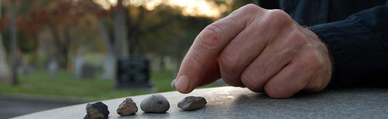 Bereavement pebbles on a headstone